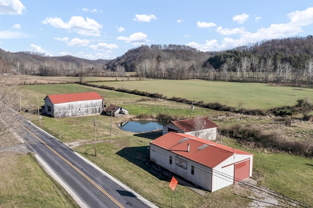 birds eye view of property featuring a mountain view and a rural view