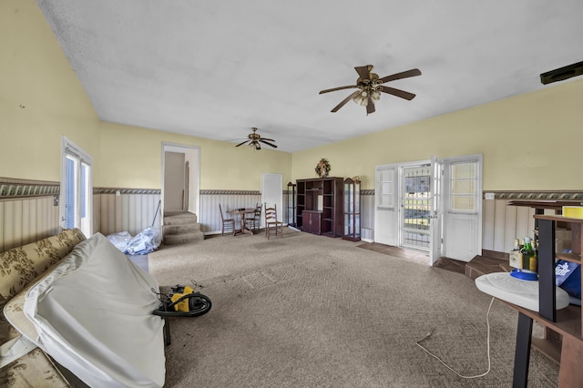 carpeted living room with ceiling fan