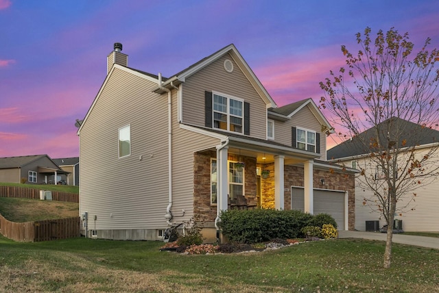 view of front of home featuring a lawn and cooling unit