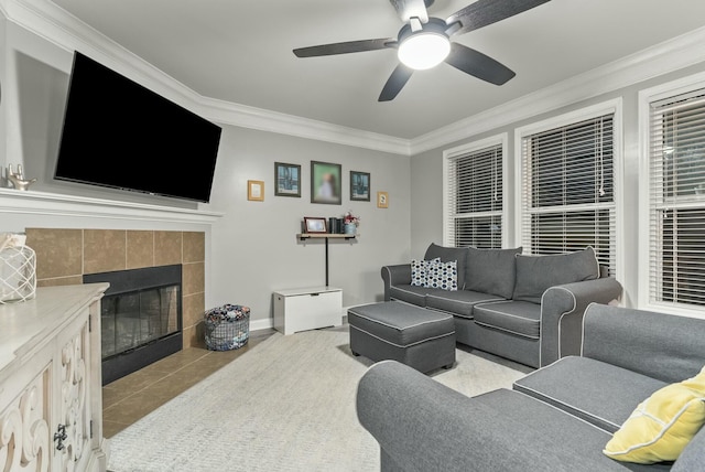 tiled living room with crown molding, a fireplace, and ceiling fan