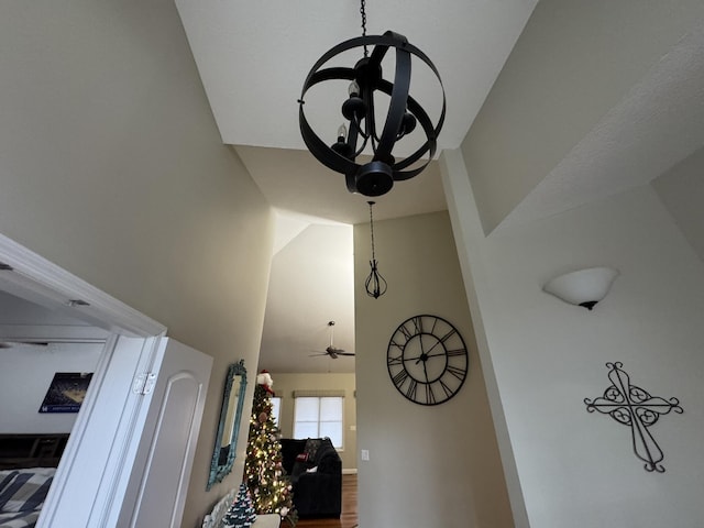 room details featuring ceiling fan with notable chandelier