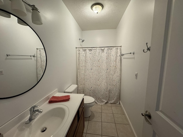 bathroom with tile patterned floors, walk in shower, vanity, a textured ceiling, and toilet