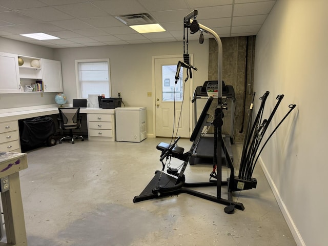 workout room with a paneled ceiling