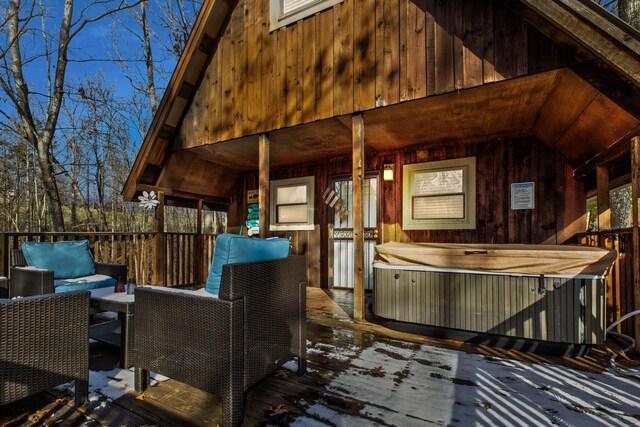 wooden terrace with an outdoor hangout area and a hot tub