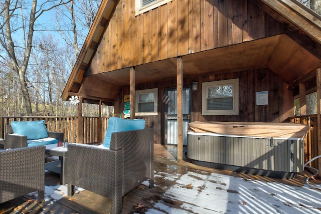 wooden deck with outdoor lounge area and a hot tub