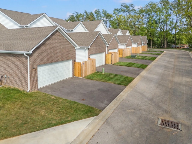 view of front of home featuring a front yard and a garage