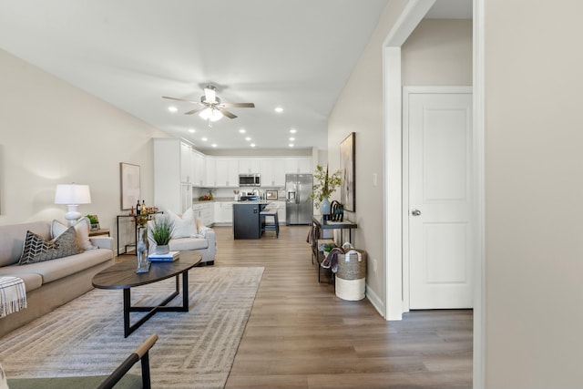 living room with ceiling fan and hardwood / wood-style floors