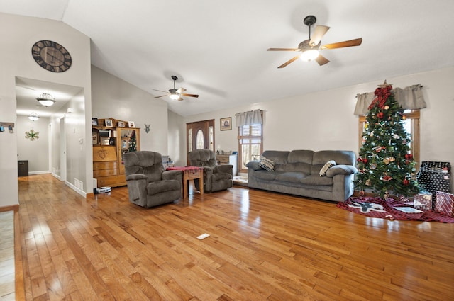 living room featuring light wood-type flooring, vaulted ceiling, and ceiling fan