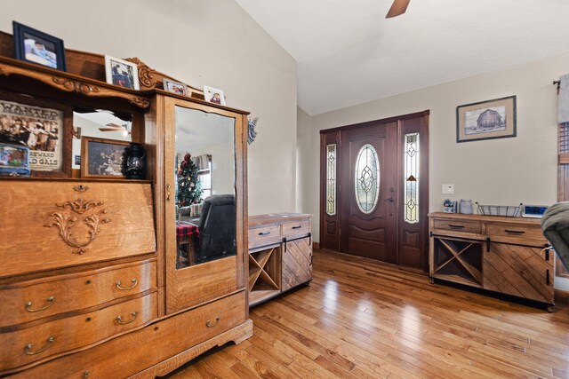 entrance foyer featuring ceiling fan, lofted ceiling, and light hardwood / wood-style flooring