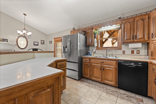 kitchen featuring pendant lighting, dishwasher, sink, stainless steel refrigerator with ice dispenser, and vaulted ceiling