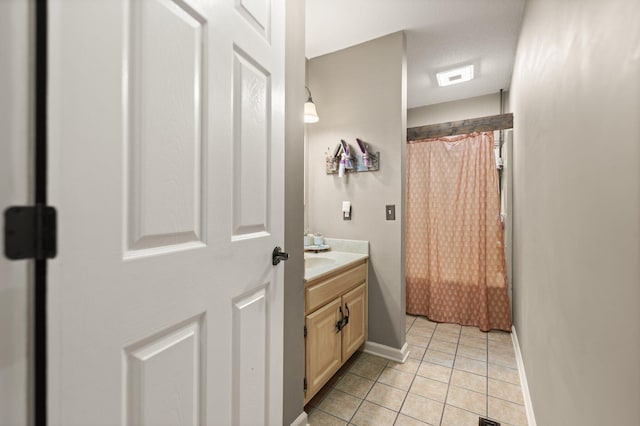 bathroom featuring a textured ceiling, vanity, tile patterned floors, and curtained shower