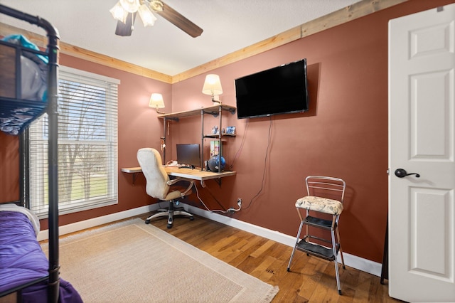 office featuring hardwood / wood-style flooring, ceiling fan, and a healthy amount of sunlight