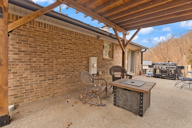 view of patio with grilling area and a fire pit