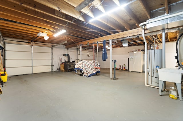 garage with gas water heater and white fridge with ice dispenser