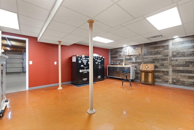 basement with a paneled ceiling