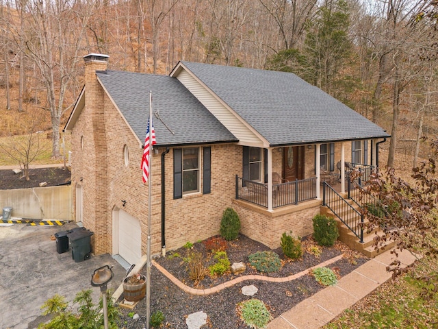 view of front facade featuring a porch and a garage