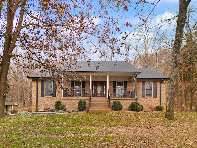 ranch-style home with covered porch and a front yard