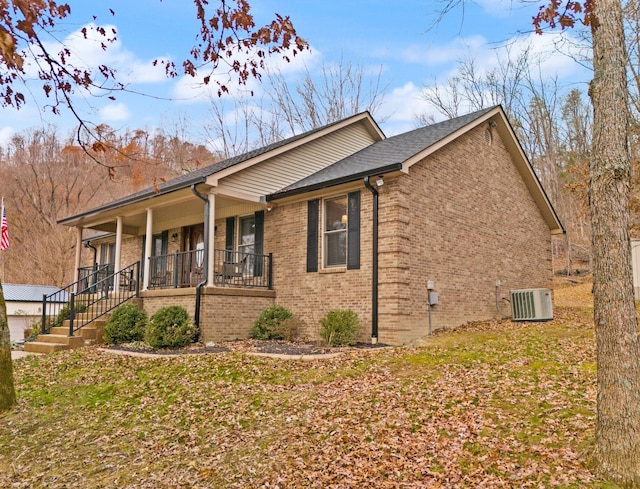 view of side of property featuring cooling unit and a porch