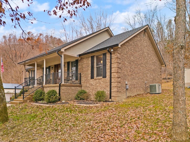 view of side of home with a porch and central air condition unit