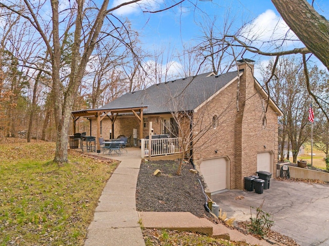 view of front of property featuring a patio and a garage