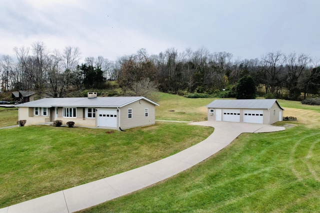 view of front facade with an outbuilding and a front lawn