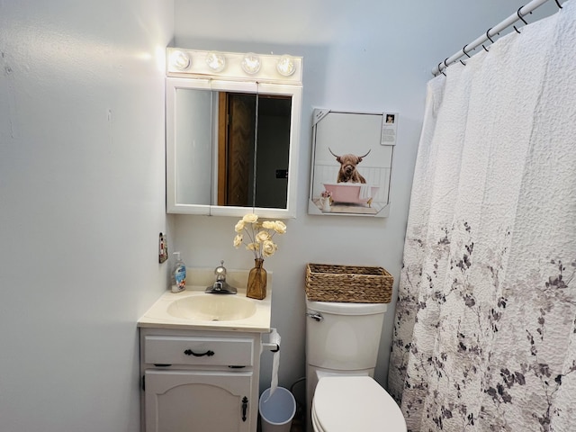 bathroom featuring vanity, a shower with shower curtain, and toilet