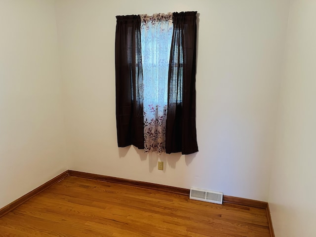 empty room featuring wood-type flooring