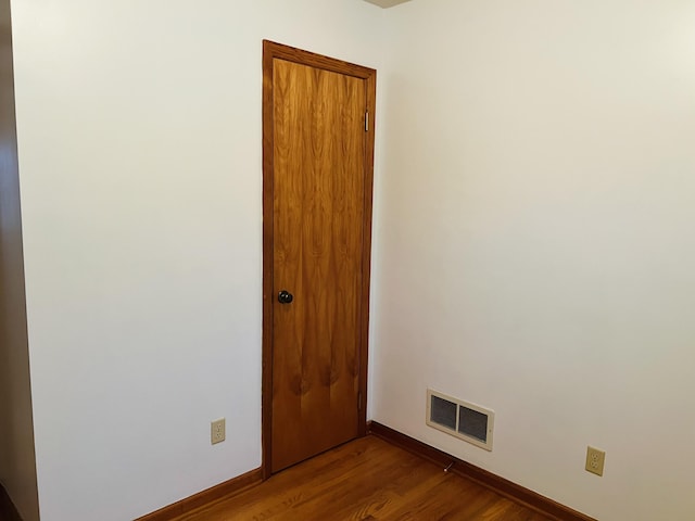 spare room with wood-type flooring