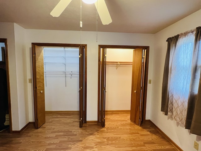 unfurnished bedroom featuring a closet, light hardwood / wood-style flooring, and ceiling fan