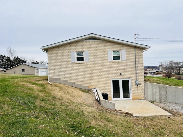 back of house with a lawn and a patio area