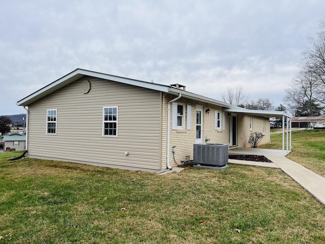 view of home's exterior featuring cooling unit and a lawn