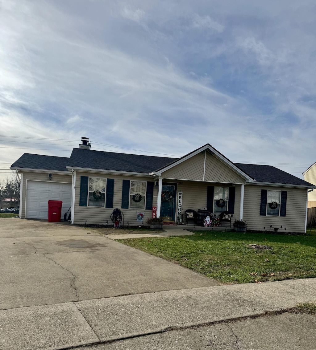 single story home with a front lawn and a garage