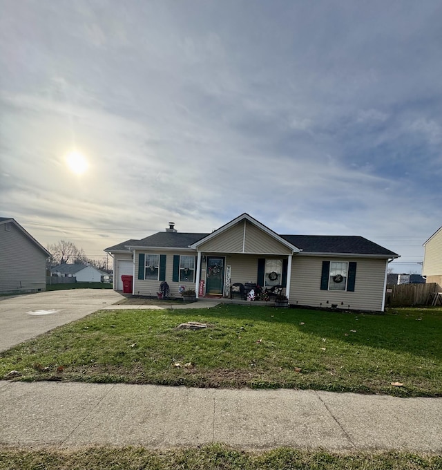 single story home with covered porch, a front yard, and a garage