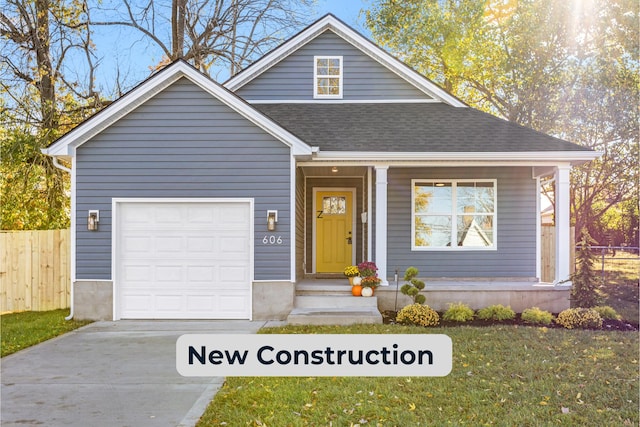 view of front of property featuring a front lawn and a garage