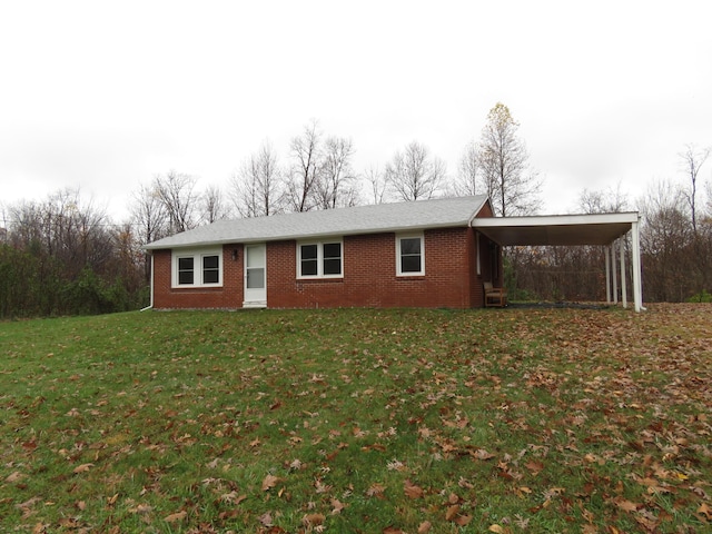 view of front of home with a front lawn and a carport