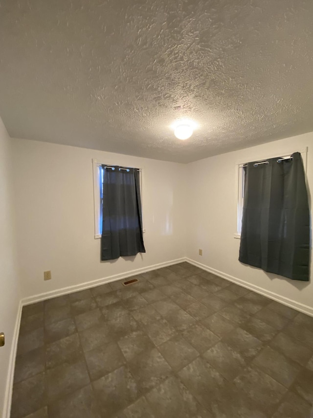 empty room featuring a textured ceiling