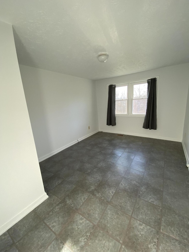 empty room with a textured ceiling