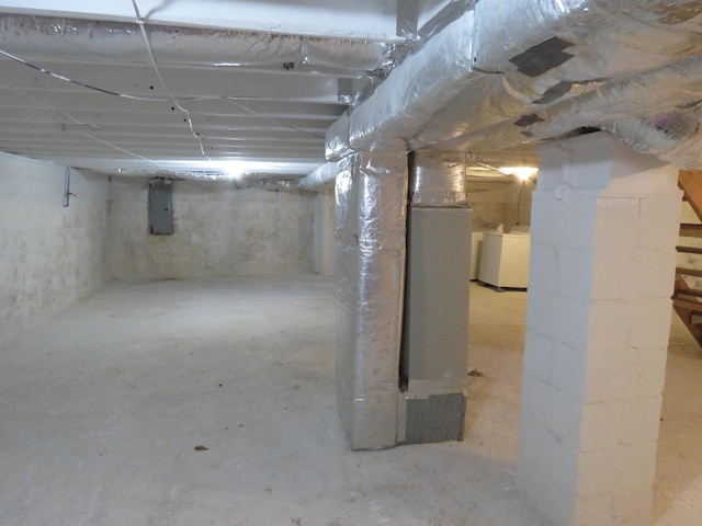 basement with electric panel and washer and dryer