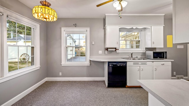 kitchen with light carpet, sink, dishwasher, white cabinetry, and hanging light fixtures