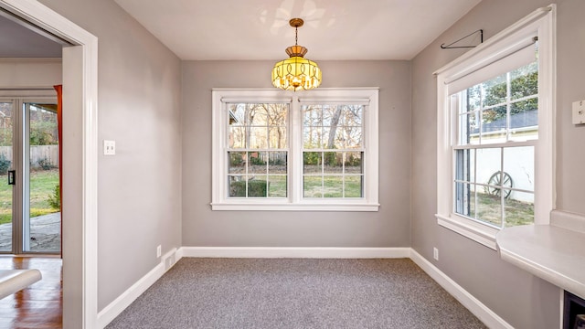 unfurnished dining area with a healthy amount of sunlight and an inviting chandelier