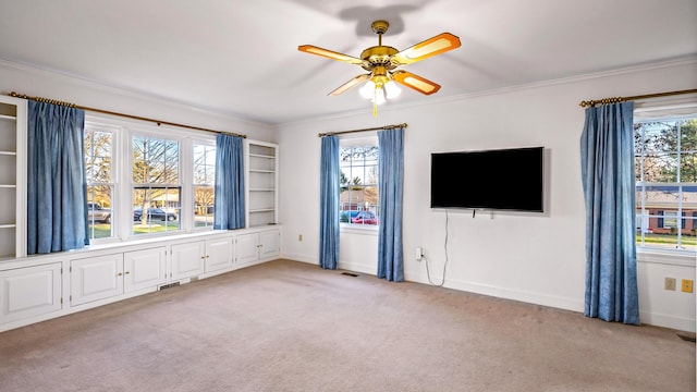 unfurnished living room with light colored carpet, plenty of natural light, and ornamental molding