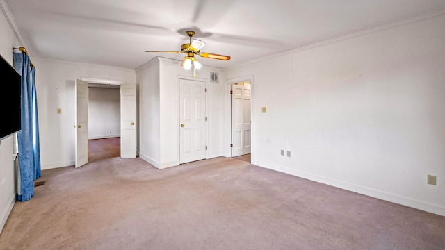 spare room featuring carpet, ceiling fan, and ornamental molding