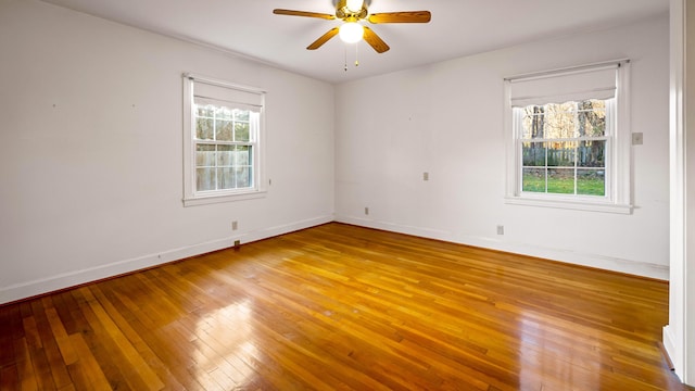 empty room featuring hardwood / wood-style floors and ceiling fan