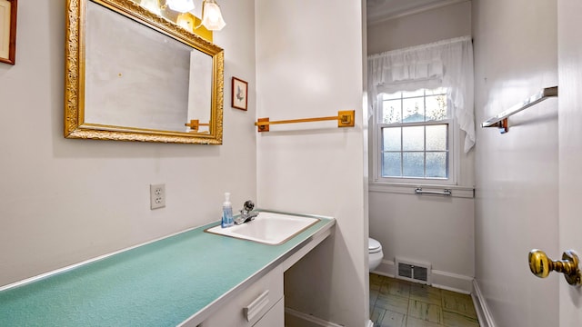 bathroom featuring vanity and toilet