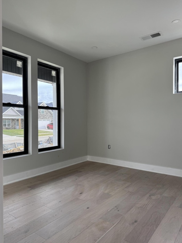 unfurnished room with light hardwood / wood-style floors