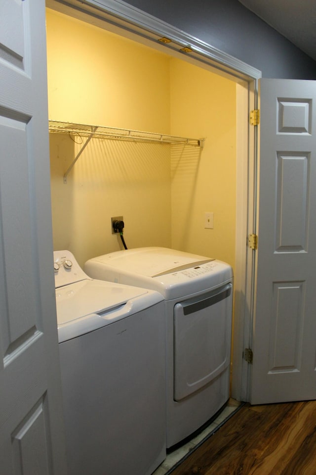 laundry area with separate washer and dryer and dark wood-type flooring