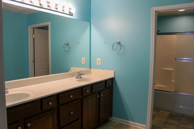 bathroom featuring tile patterned floors, vanity, and enclosed tub / shower combo