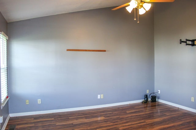 empty room with dark hardwood / wood-style flooring, ceiling fan, and lofted ceiling