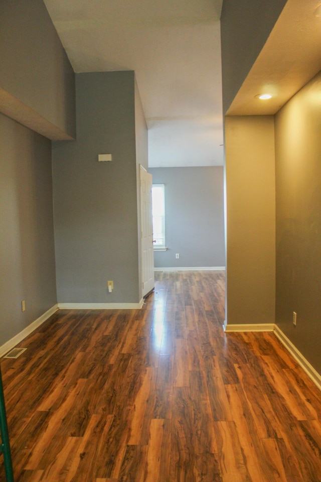 unfurnished room featuring dark hardwood / wood-style flooring