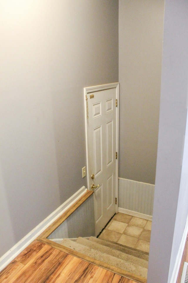 stairs featuring hardwood / wood-style flooring